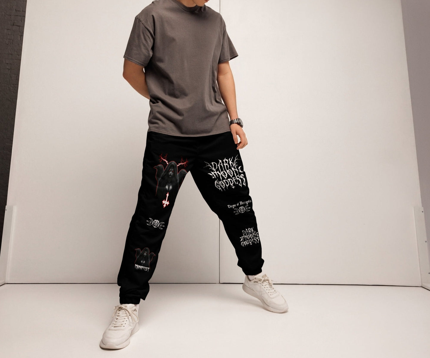 model wearing Black Joggers Pants Sweats Alternative Streetwear Lilith Ravens Inverted Cross Triple Moon Goddess Triple Moon Seal Sigil Throne of Necropolis Witch Occult Witchcraft Goetia side angle view