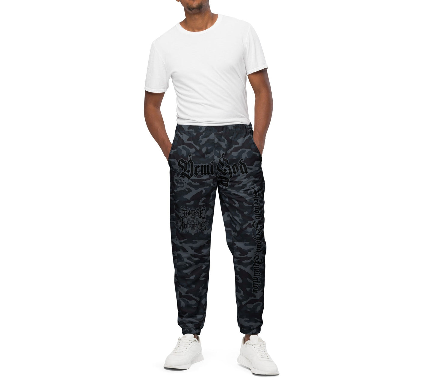 Model wearing Dark Camo Joggers pants sweats with Demigod on crotch Strength Beyond Limitation on Left Leg and Throne of Necropolis logo on right leg front view